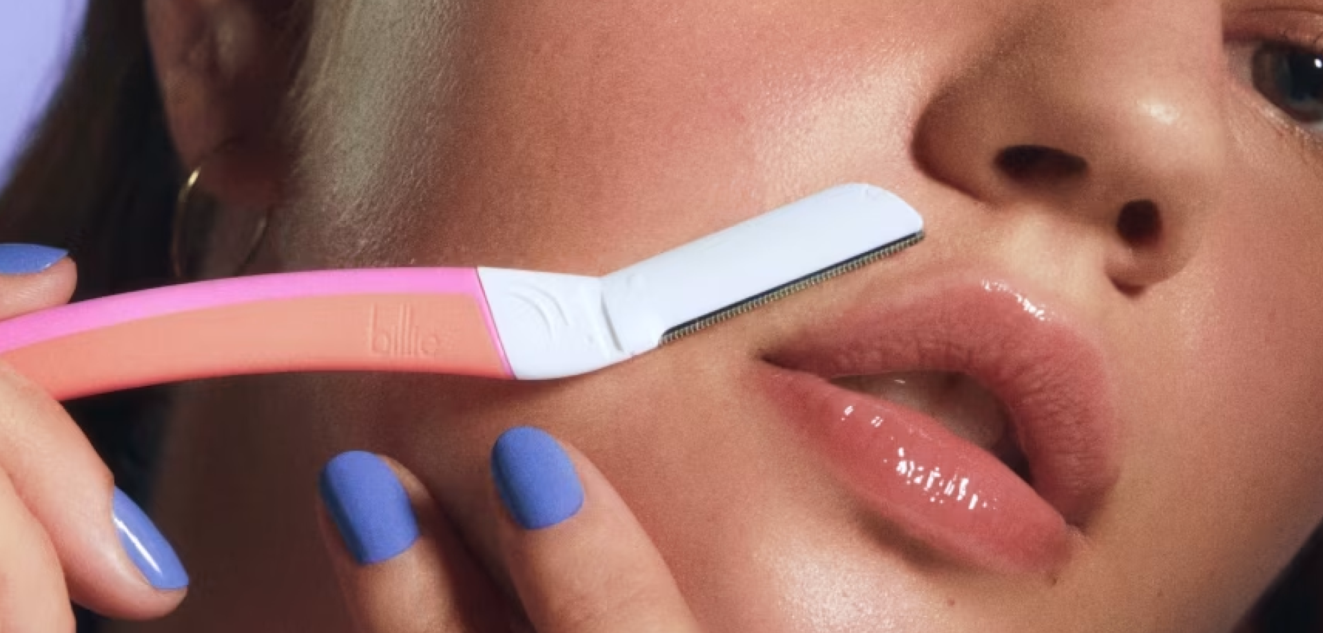 A girl using Billie Dermaplane to remove hair from her upper lip