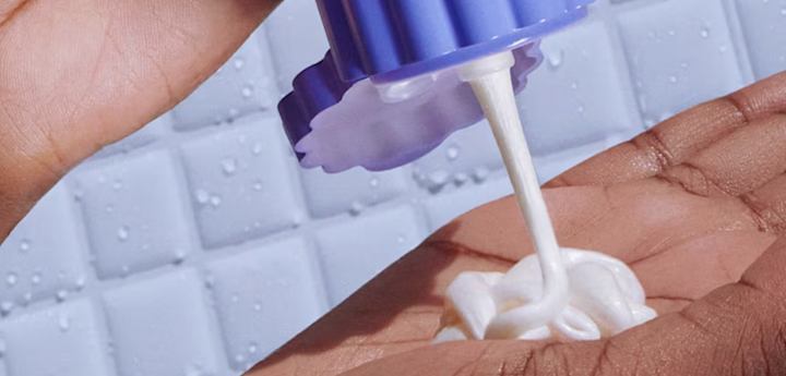 Close up photograph of Billie Whipped Shave Cream being squeezed out of the bottle into a hand